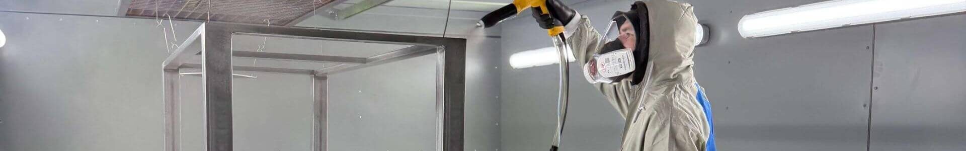 Powder Pro team member powder coating table legs in Devon workshop